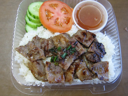 Grilled pork rice platter in a to go order