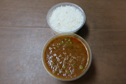 Aloo mutter in a takeout container